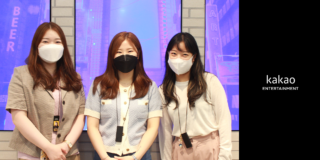 Three employees from Kakao Entertainment's global webtoon content team business pose in front of blue and purple background.